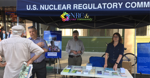 An NRC Region IV team staffs a booth at the San Luis Obispo Market Night to speak with local residents about the agency's role in overseeing nuclear plants, including the nearby Diablo Canyon site.