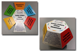 Photo of colapsible, cardboard pop-ups available, which are convenient desktop references for the Safety Culture Policy Statement definition and traits; they are hexagon shaped with information on each side of the various colored tabs